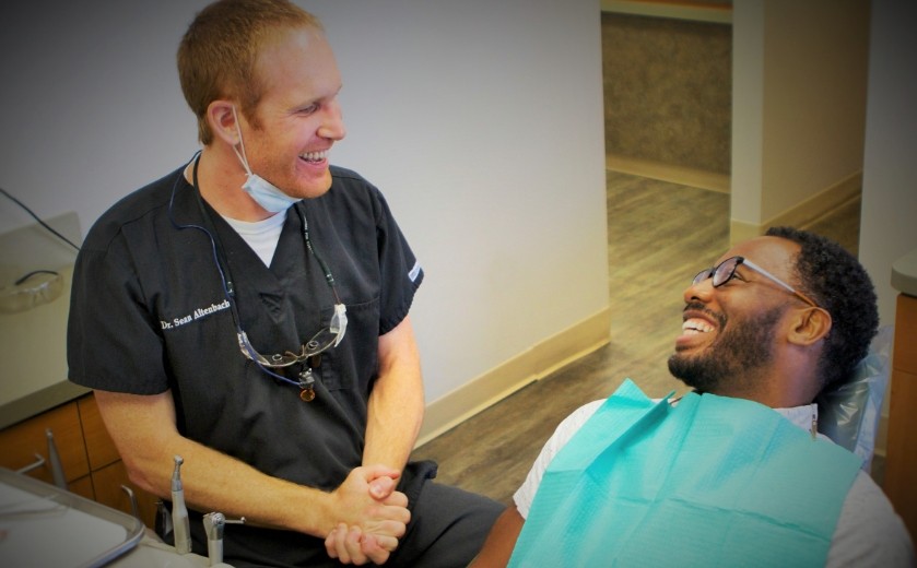 Doctor Altenbach laughing with a dental patient
