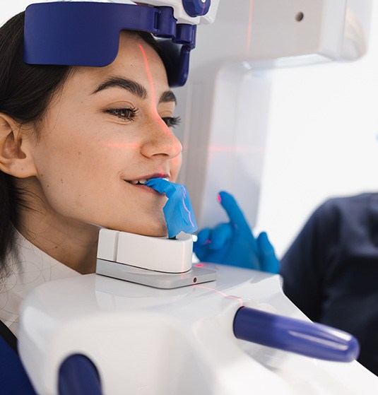 a patient having a cone beam CT scan taken of their face