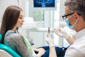 Patient talking to a dentist about dental implants