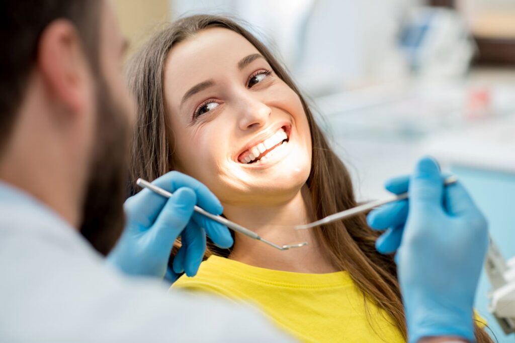 A woman smiling at her dental appointment